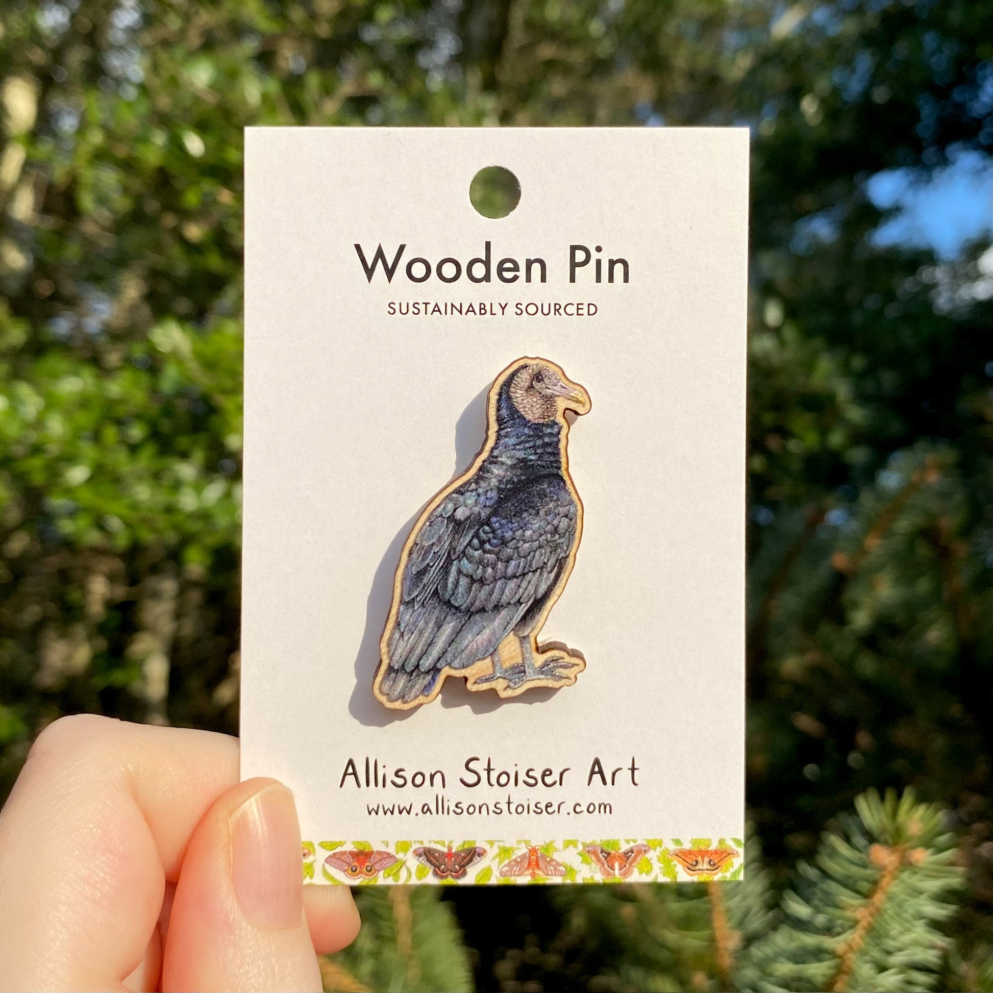 A wooden pin of a black vulture