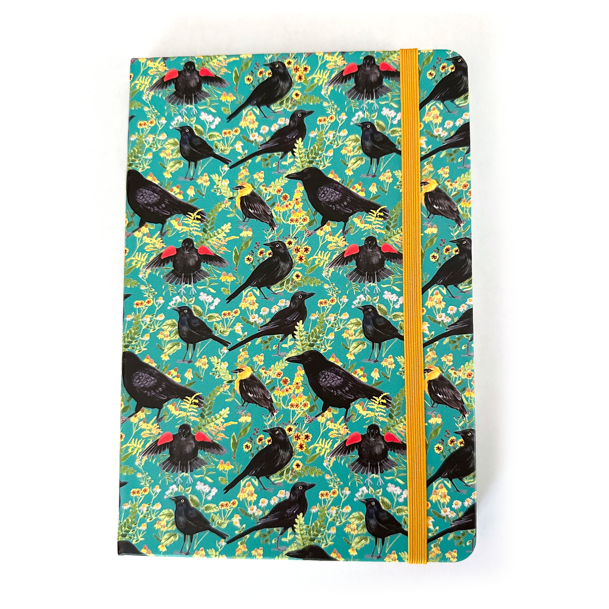 Notebook with black bird and flower pattern on a teal background
