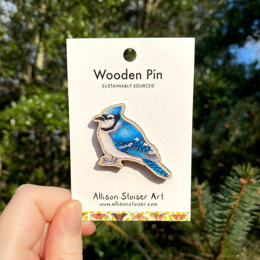 A wooden pin of a blue jay