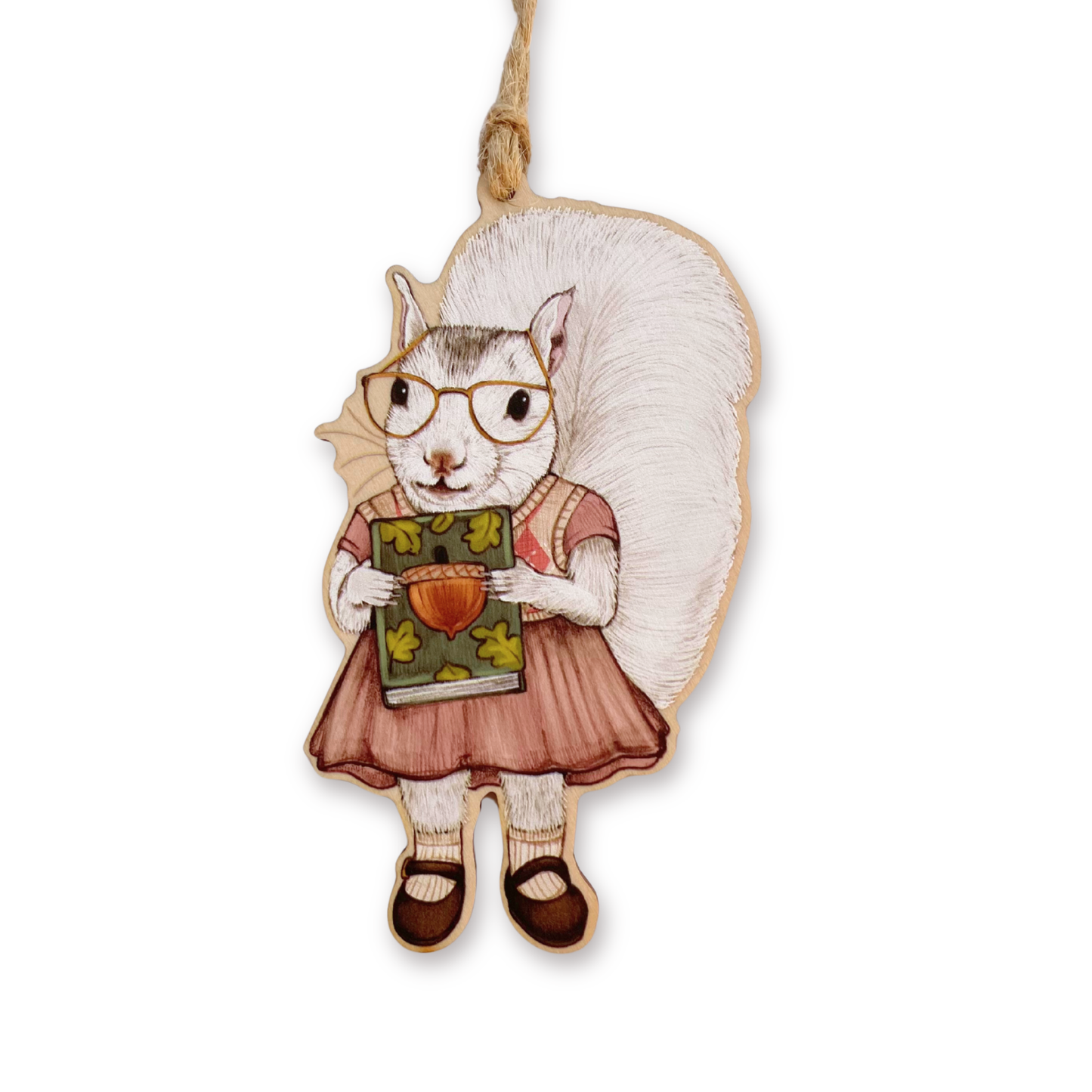 Decorative ornament of a squirrel wearing glasses and holding a book on a white background