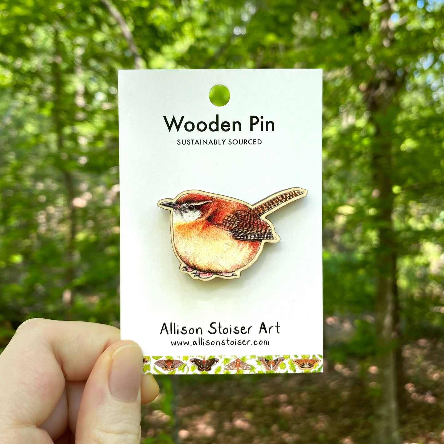 A wooden pin of a Carolina wren 