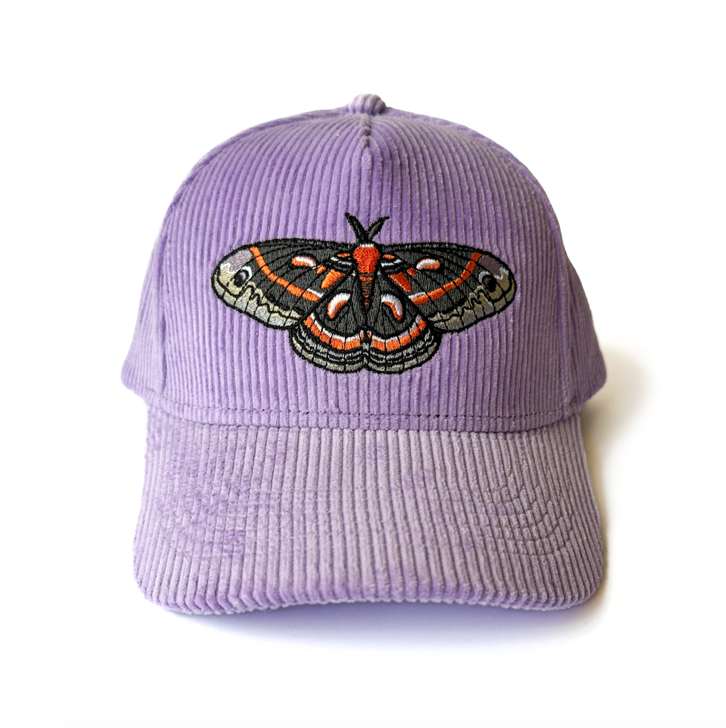 Purple corduroy cap with a cecropia moth embroidered on a white background