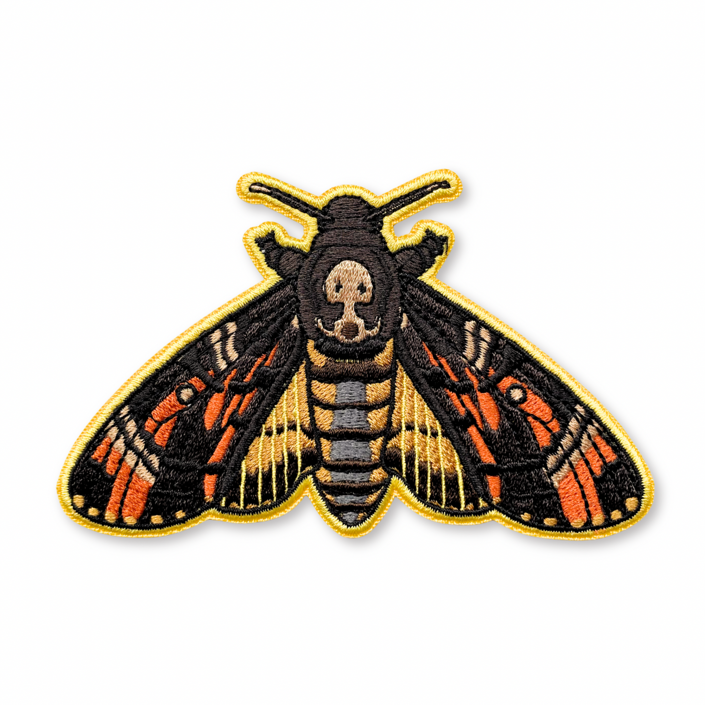Embroidered patch of a death's head hawkmoth on a white background