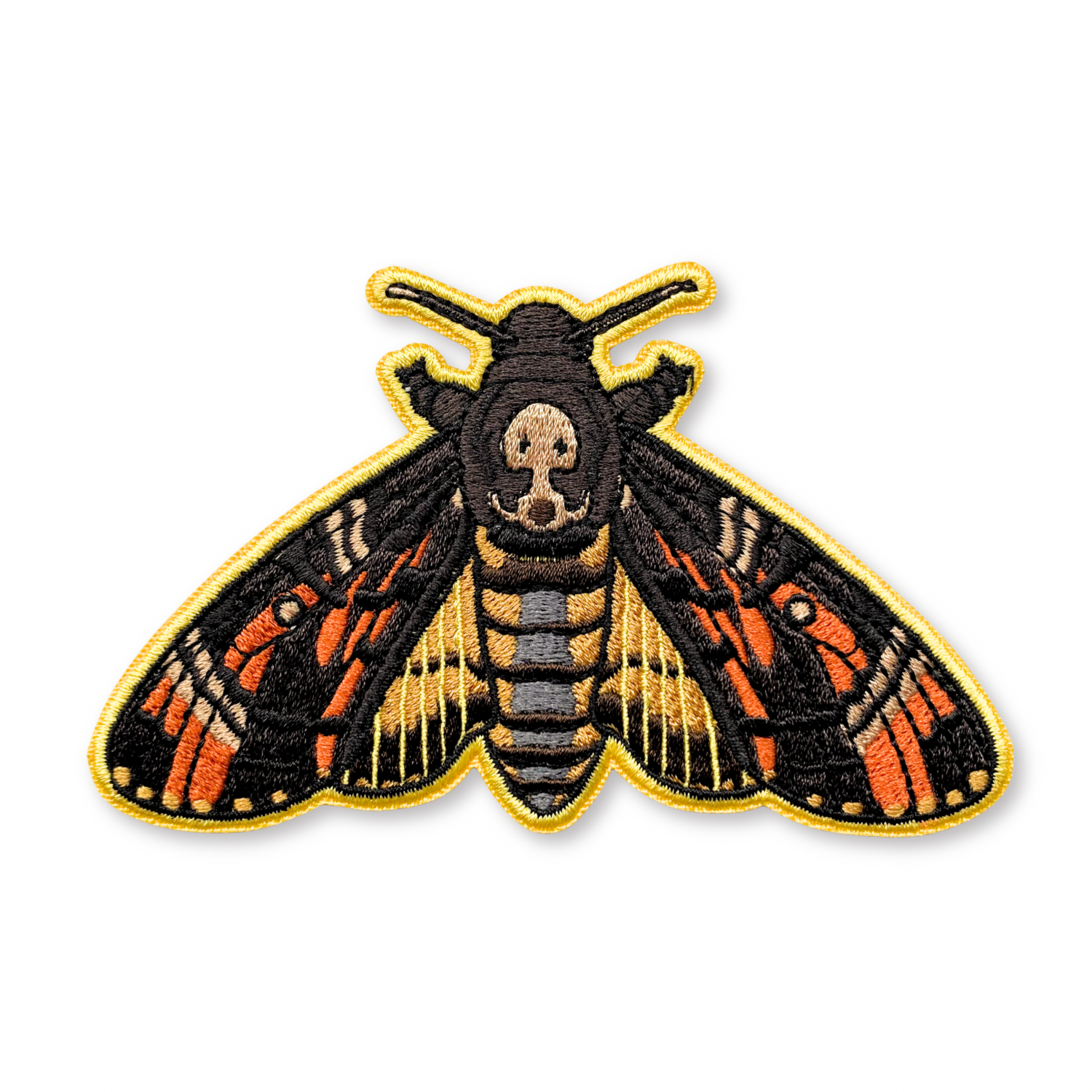 Embroidered patch of a death's head hawkmoth on a white background