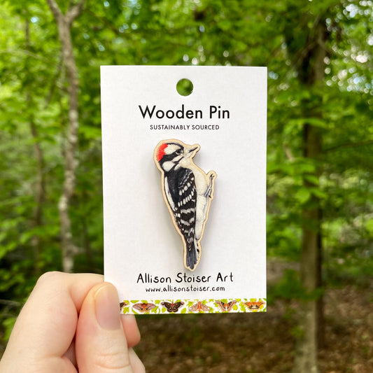 A wooden pin of a downy woodpecker