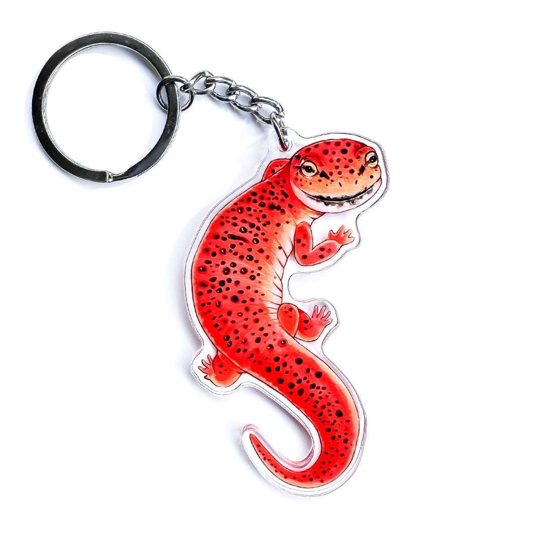 A red salamander keychain on a white background.