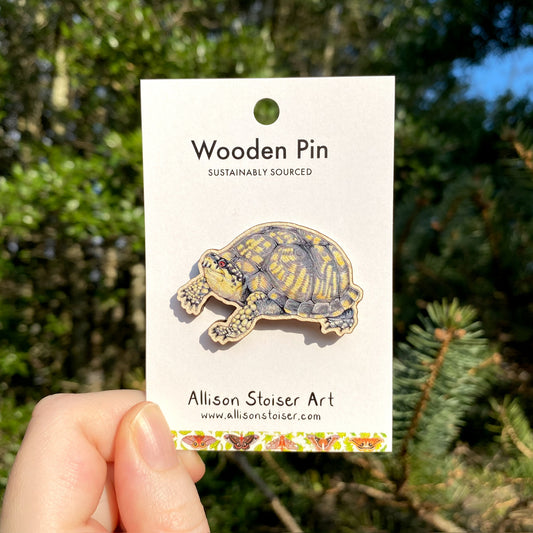 A wooden pin of an eastern box turtle