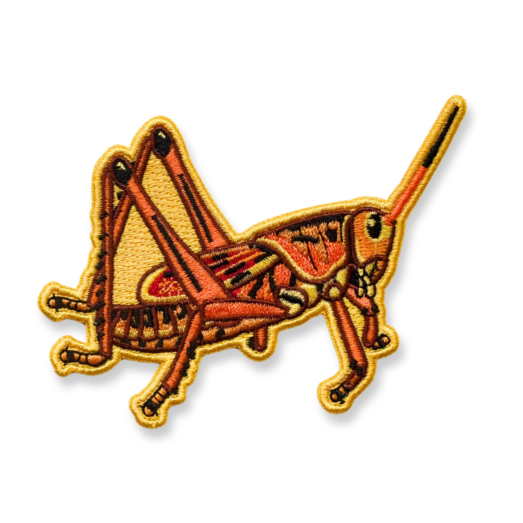 An embroidered patch of a yellow and orange grasshopper shown on a plain white background.