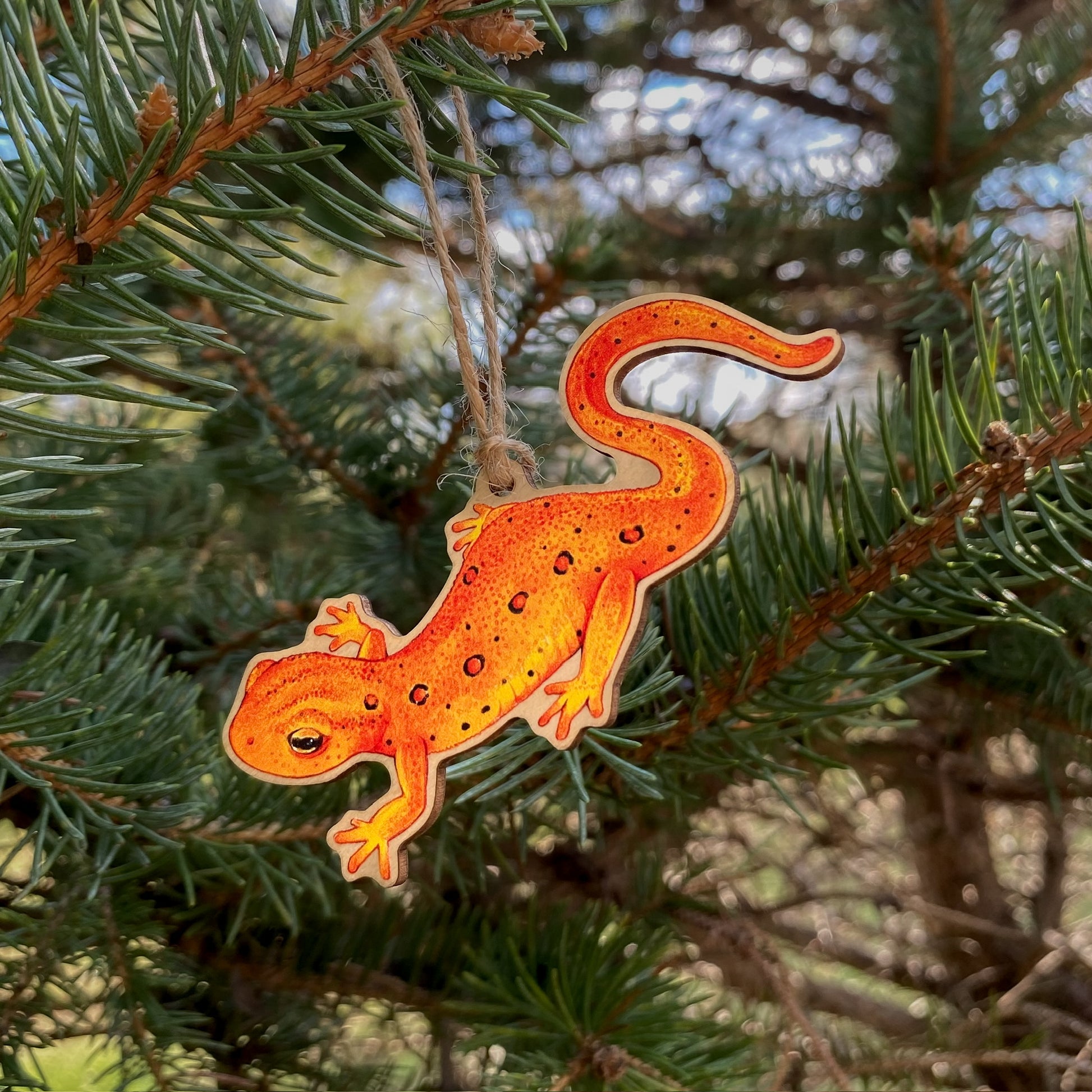 An Eastern newt eft ornament in a tree