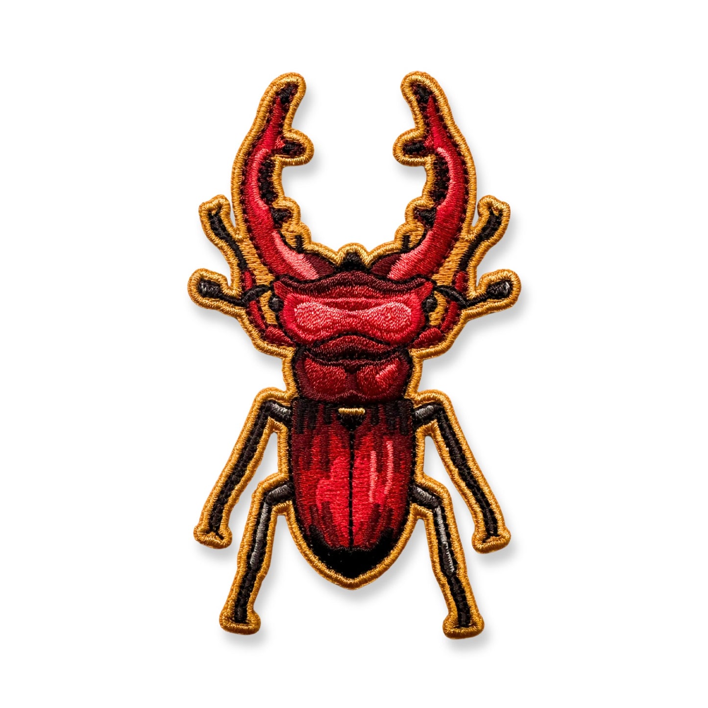 An embroidered patch of a giant stag beetle shown on a plain white background.