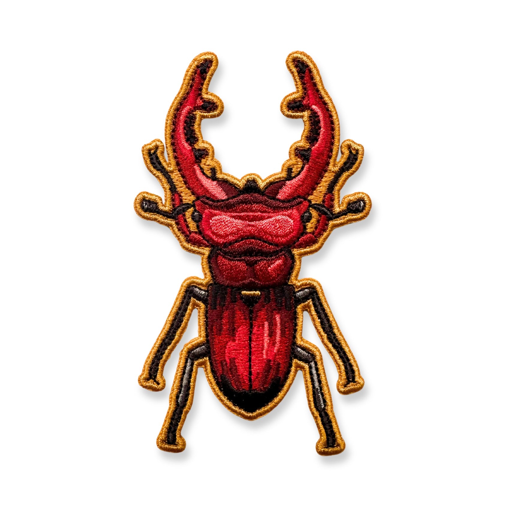 An embroidered patch of a giant stag beetle shown on a plain white background.