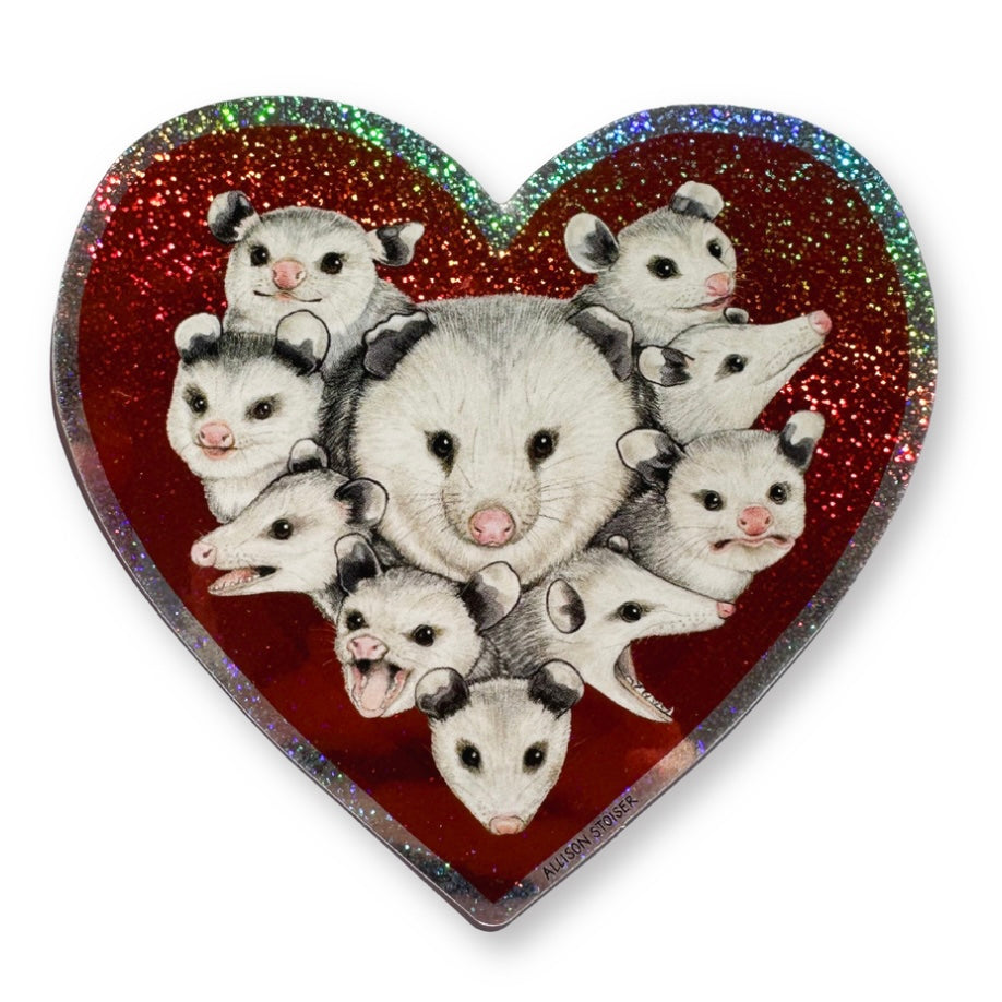 Heart-shaped glittery sticker with an arrangement of opossums on a red background