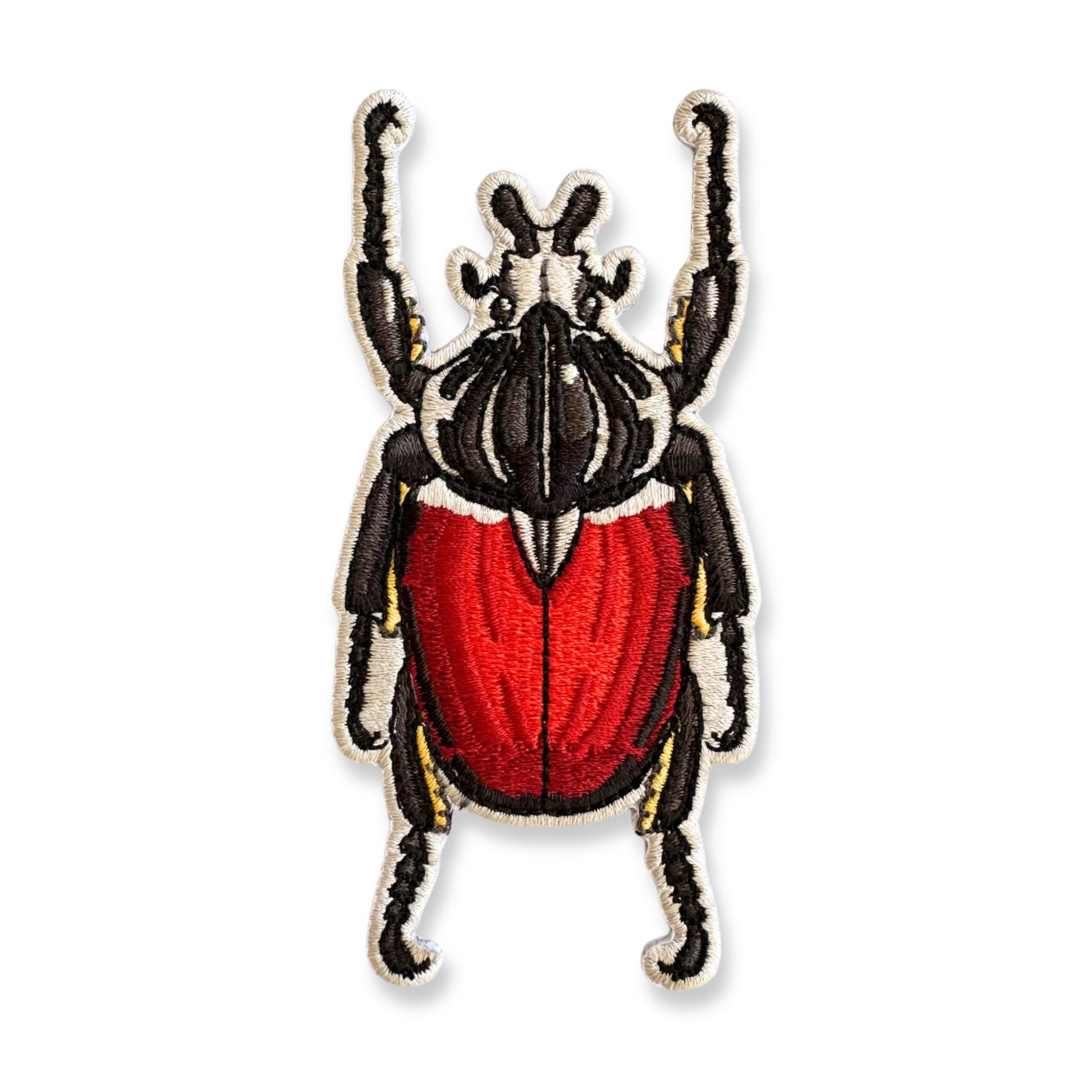 Embroidered patch of a Goliath beetle on a white background