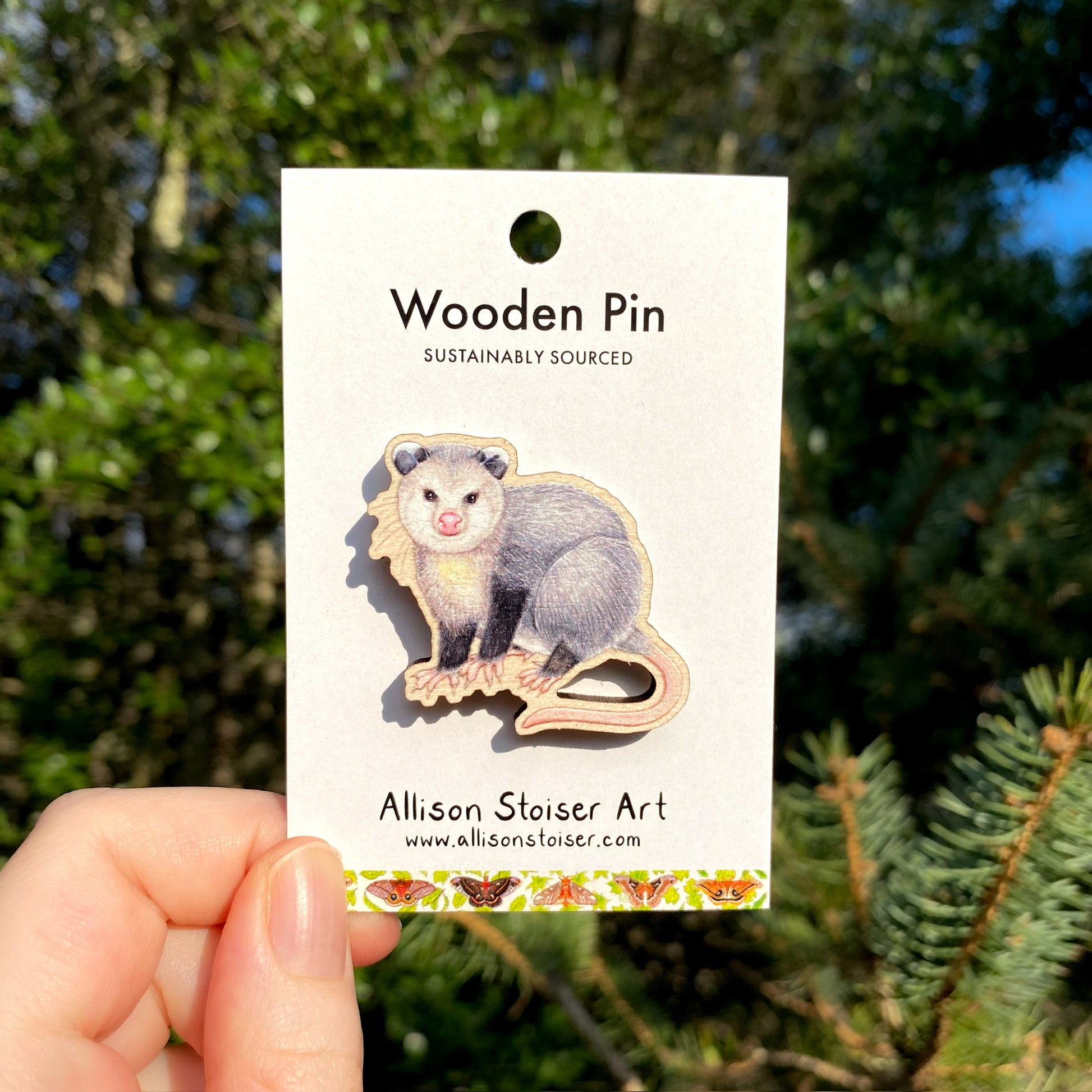 A wooden pin of a male opossum