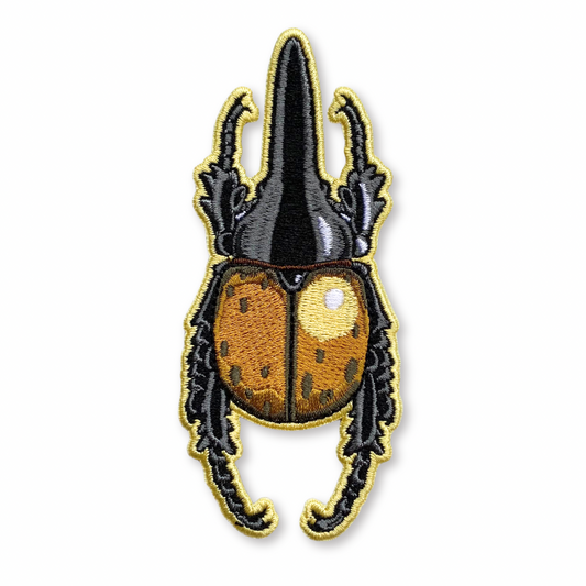 Embroidered patch of a Hercules beetle on a white background