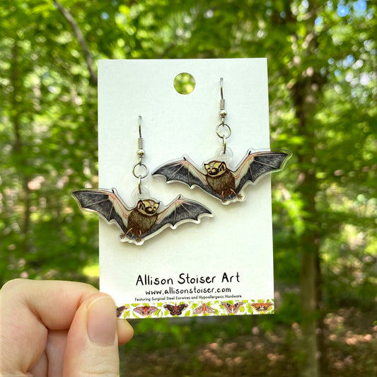 A pair of acrylic earrings with flying hoary bat charms