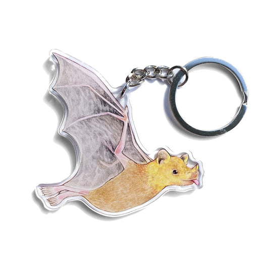 A keychain of a flying lesser long-nosed bat on a white background.