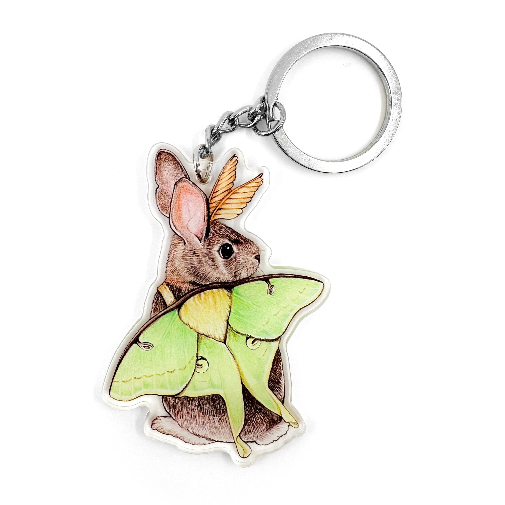 A keychain featuring an illustration of an eastern cottontail rabbit dressed like a luna moth