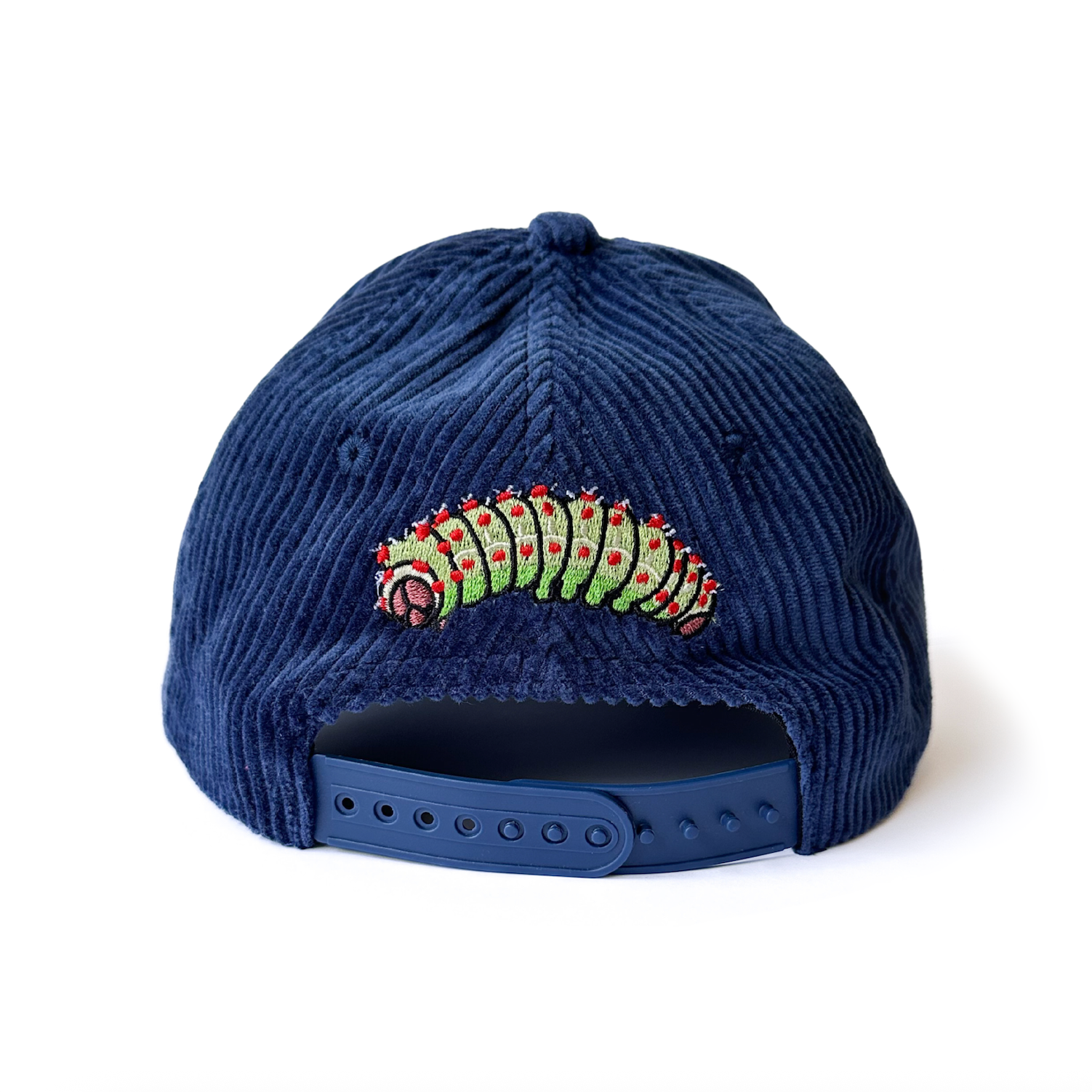 Navy blue corduroy cap with a luna moth caterpillar design on a white background