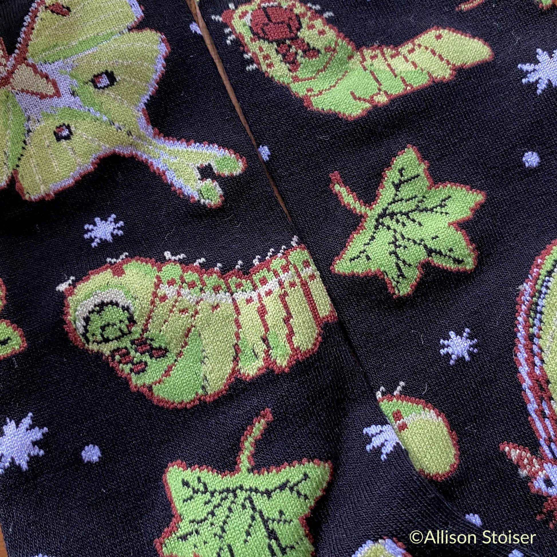 A close up of the caterpillars and moths on the luna moth socks. 