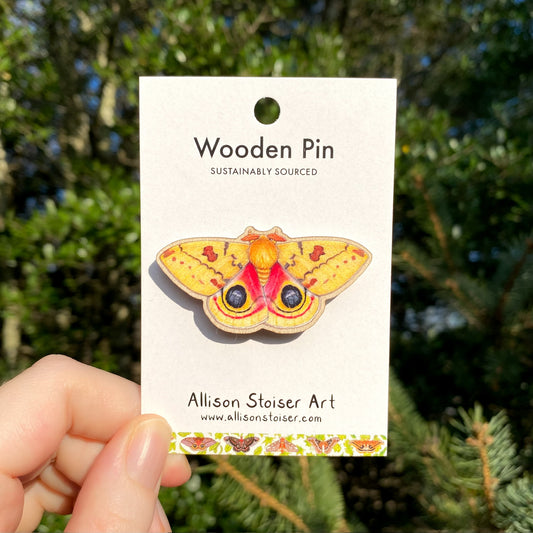 A wooden pin of a male io moth