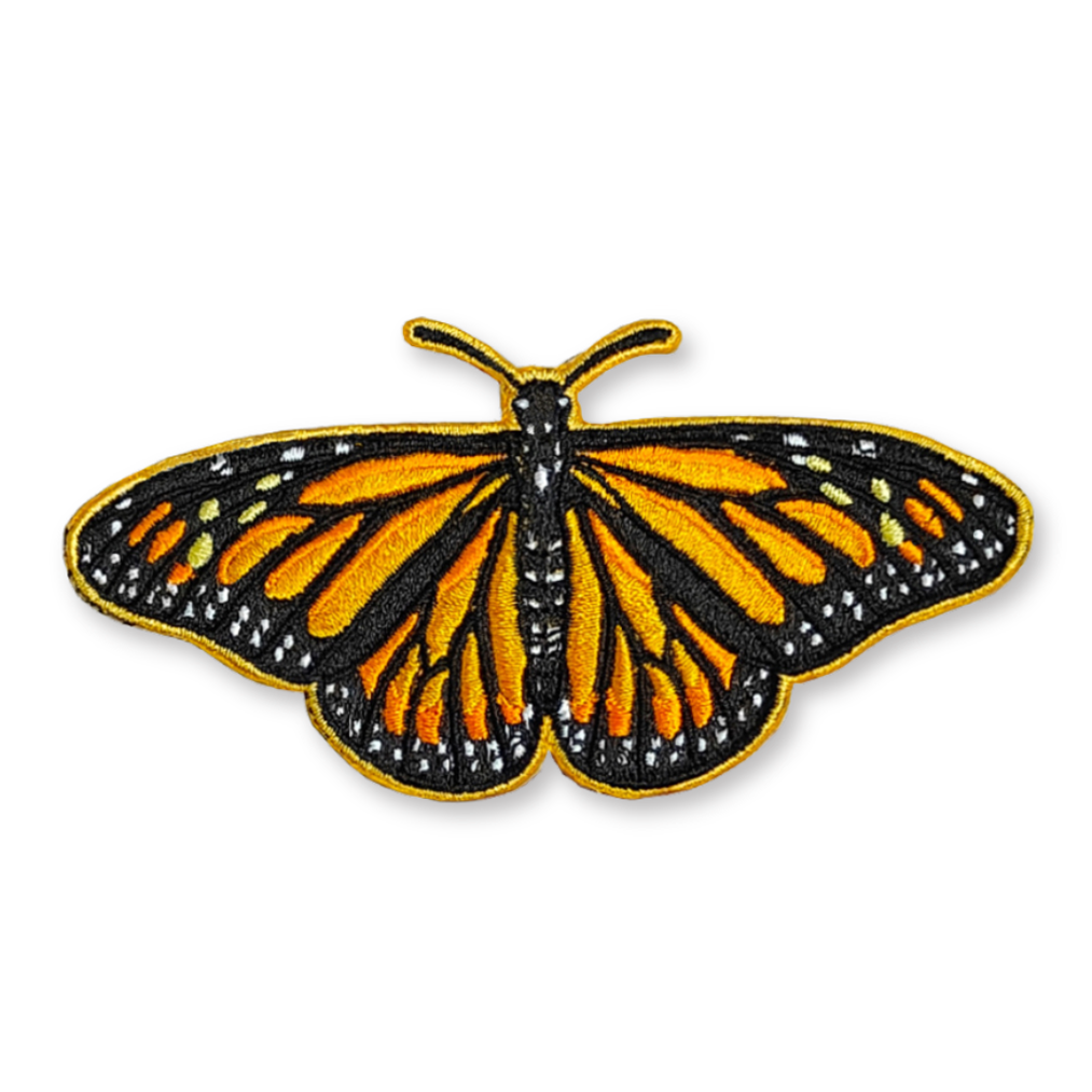 A photo of an embroidered patch of a monarch butterfly.