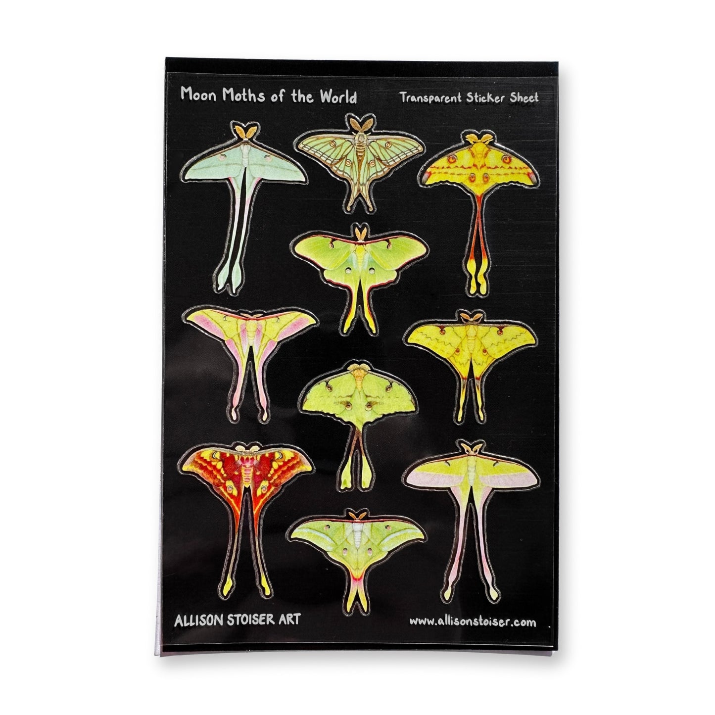 Transparent sticker sheet with moon moth illustrations on a black background