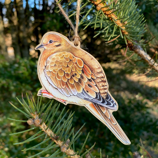 A hanging wooden ornament of a mourning dove