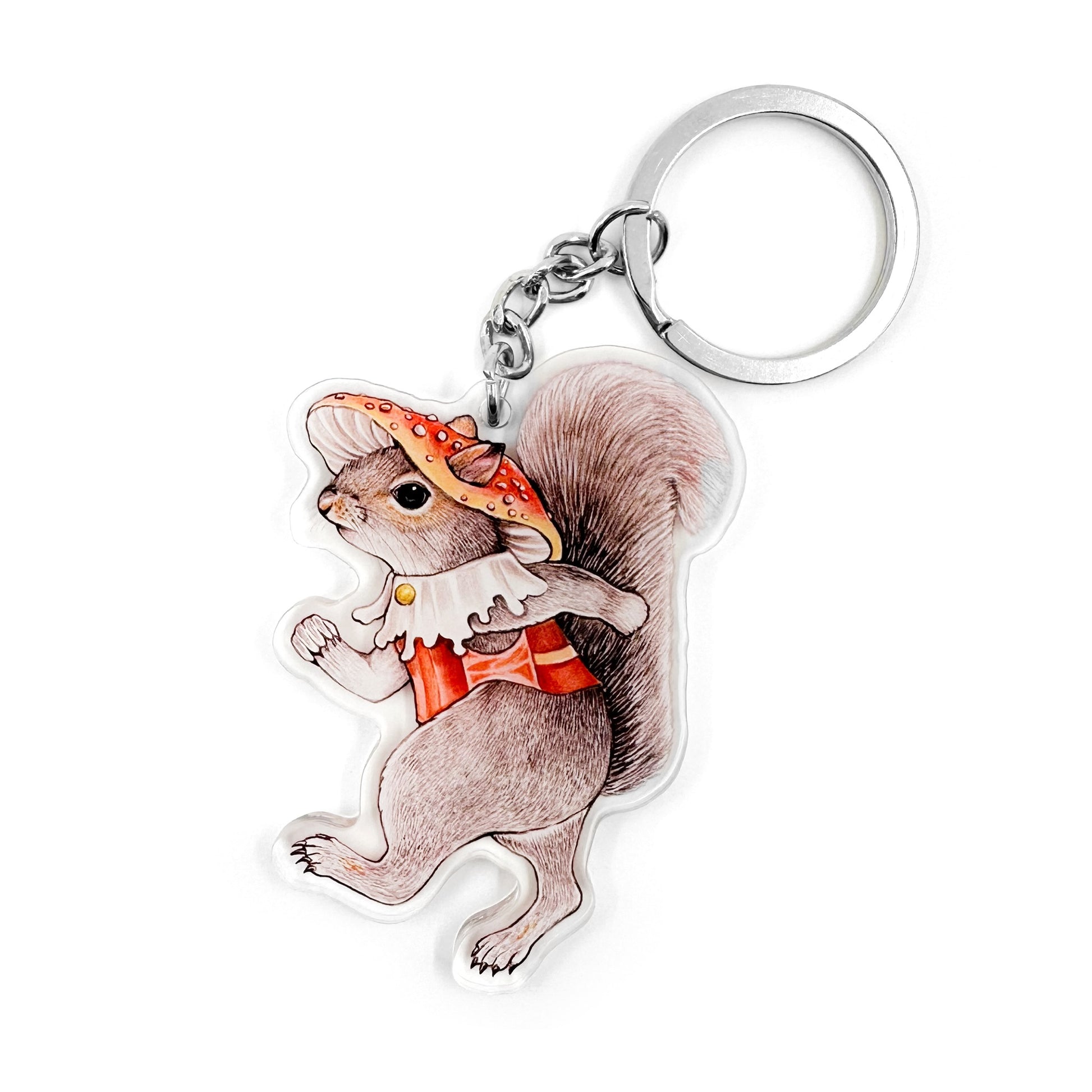 A keychain featuring an illustration of an eastern gray squirrel wearing a mushroom hat and vest