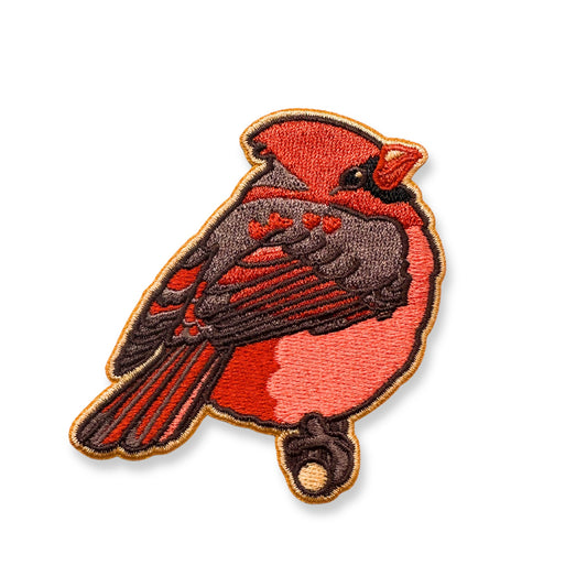 An embroidered patch of a northern cardinal shown on a plain white background.