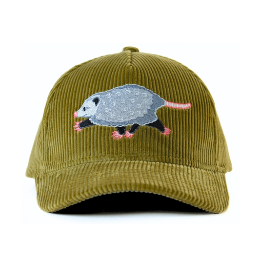 The front of an olive corduroy baseball cap with an embroidered opossum on a white background.