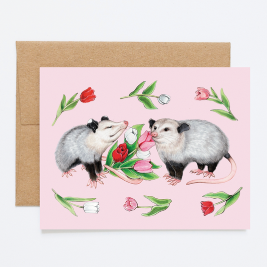 A card with opossums and tulips on a pink background