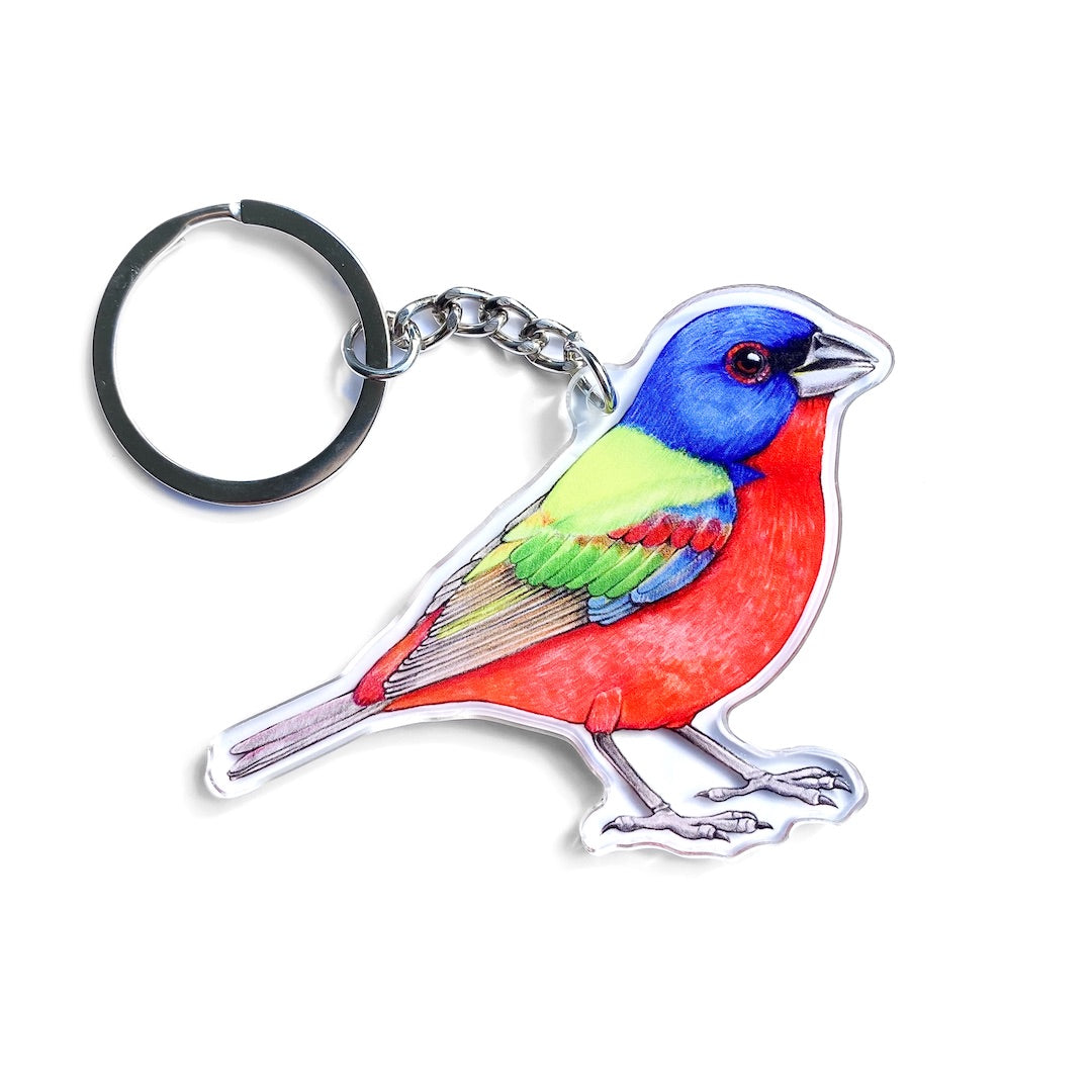 A keychain of a painted bunting on a white background.