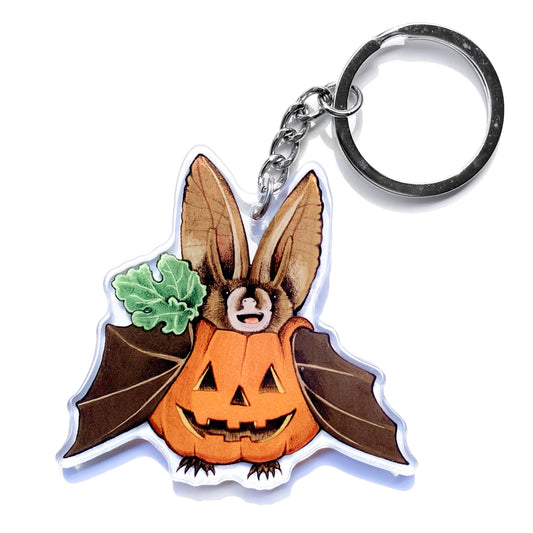 A keychain featuring my illustration of a bat dressed as a pumpkin. 