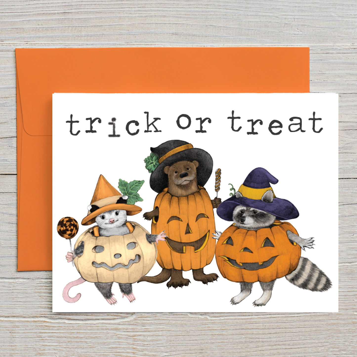 This Halloween card features my illustration of a trick-or-treating opossum, otter, and raccoon dressed as pumpkins. 