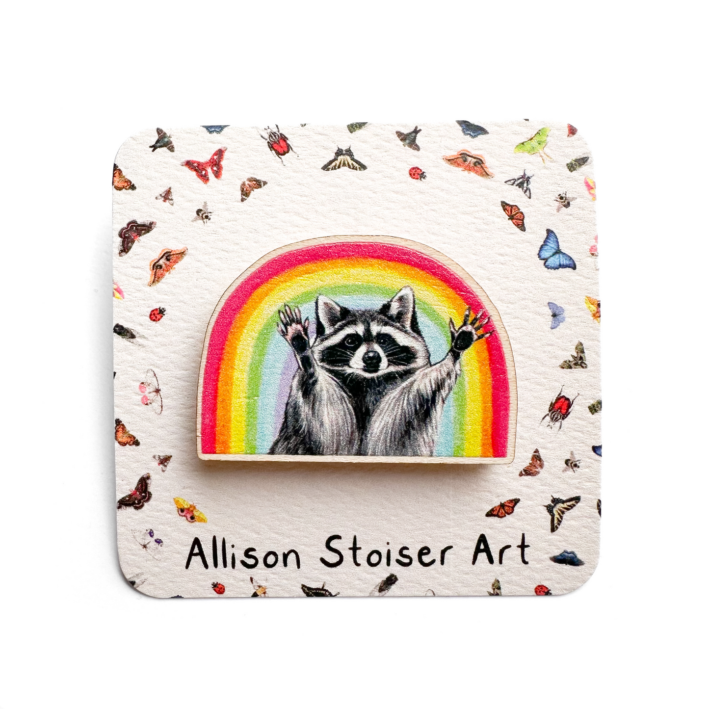 A rainbow raccoon pin