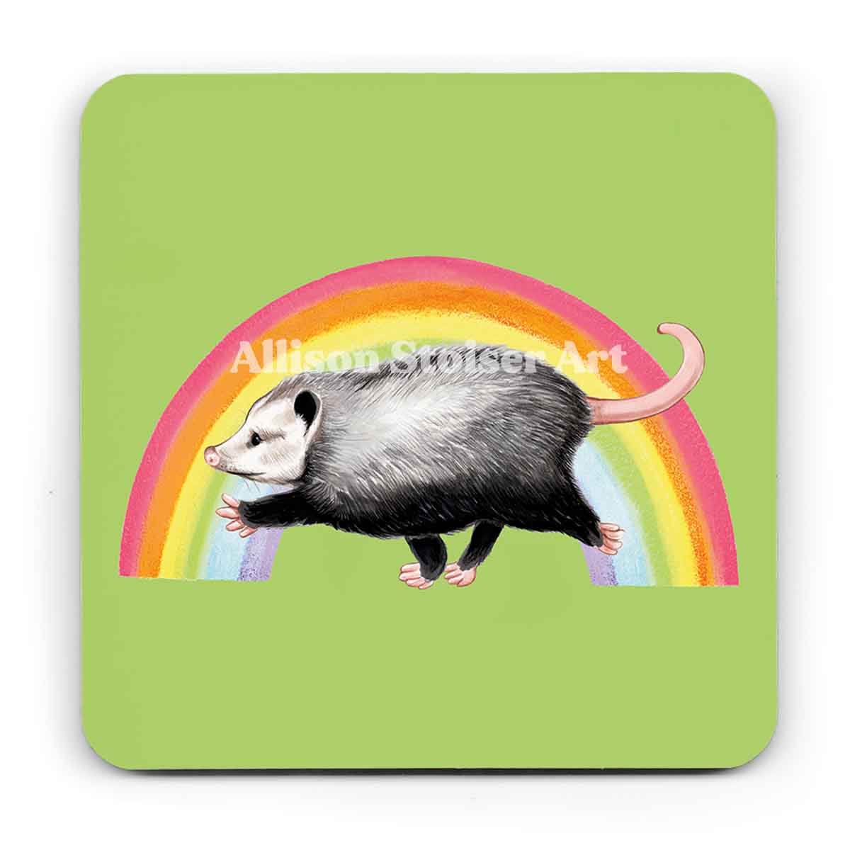 A green coaster of an opossum running in front of a rainbow on a white background.