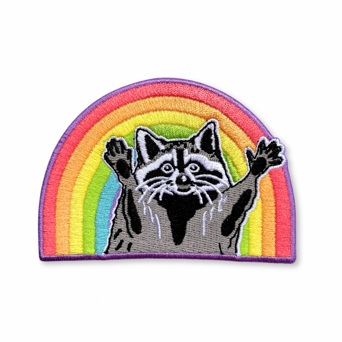 Patch with a raccoon in front of a rainbow on a white background