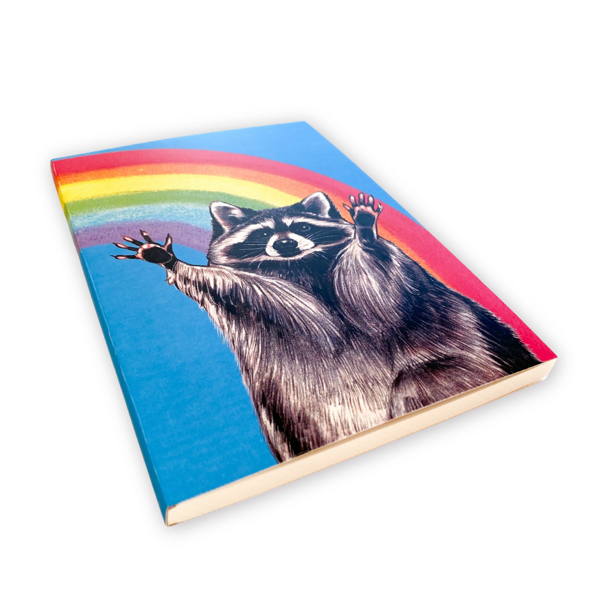 Notebook with a raccoon and rainbow design on a white background