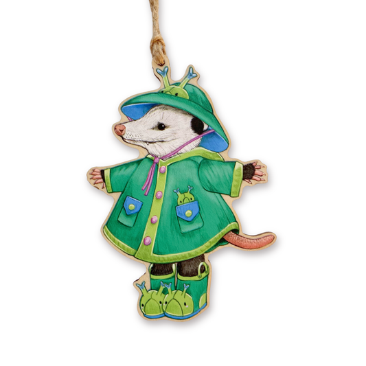 Decorative ornament of an opossum in a green raincoat with a white background