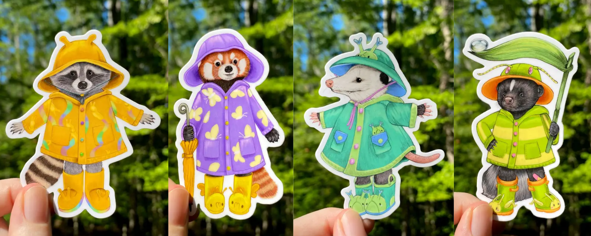 Four animal-themed raincoat stickers held against a forest background