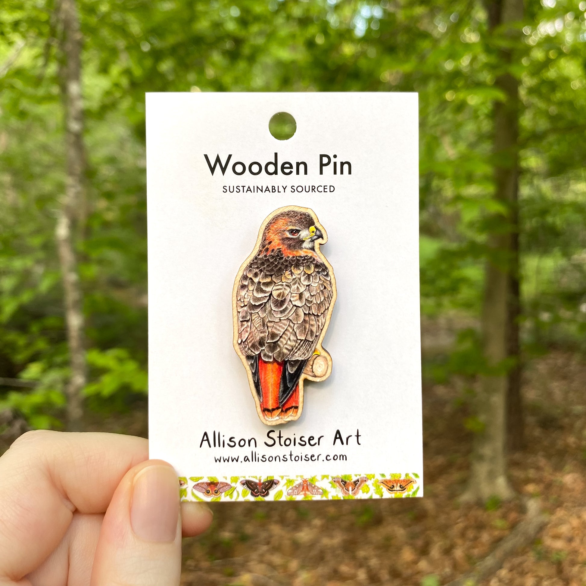A wooden pin of a red-tailed hawk