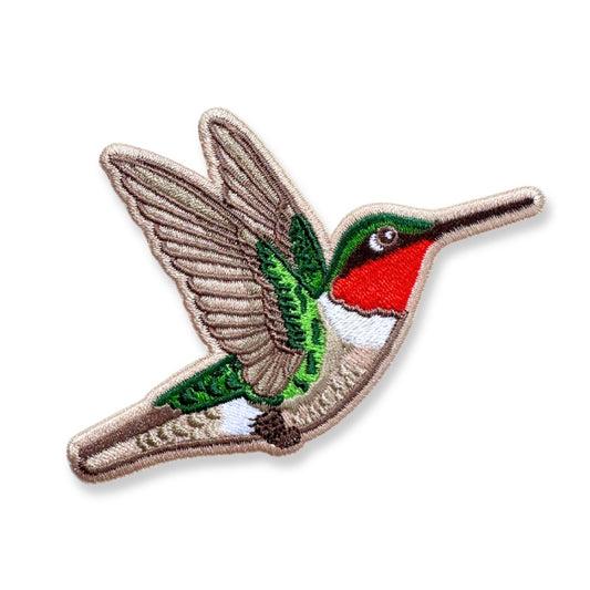 An embroidered hummingbird patch shown on a plain white background. The patch features a brown and beige body and wings, a green head and tail, a bright red chest, and a white underbelly.