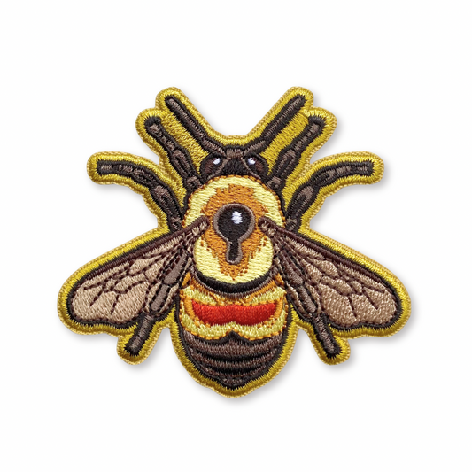 Embroidered bee patch on a white background