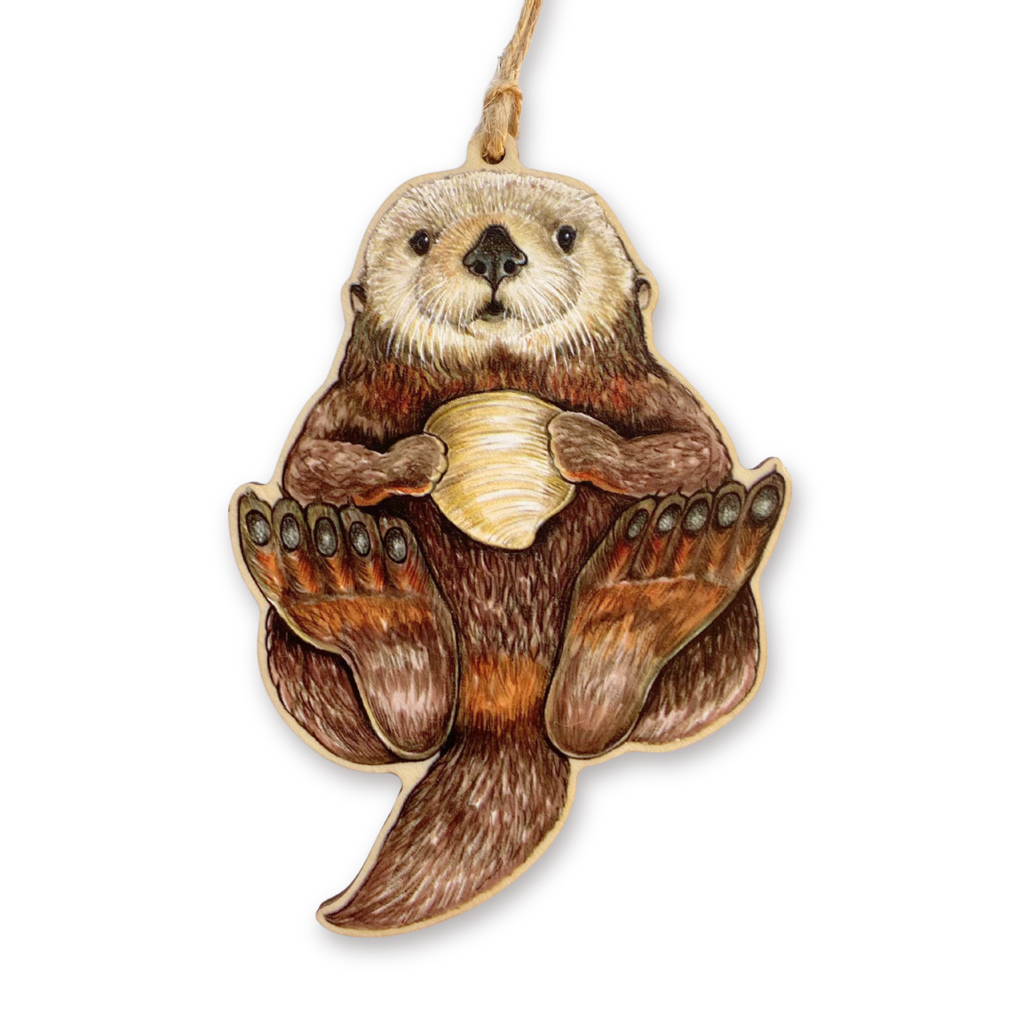 Wooden ornament of a sea otter holding a shell on a white background