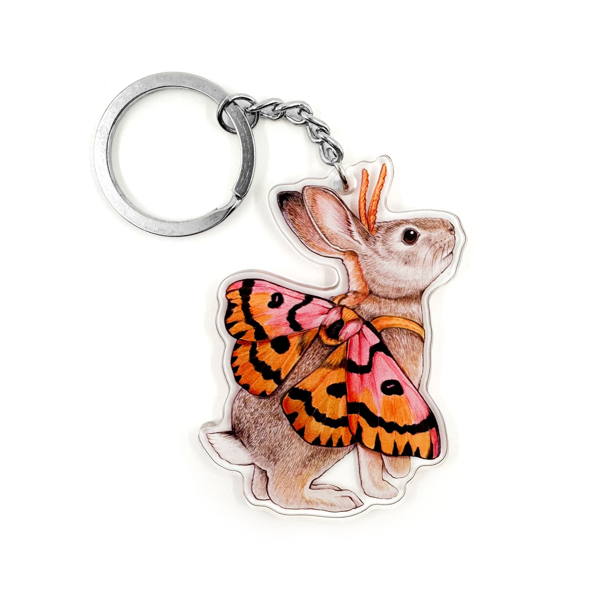 A keychain featuring an illustration of a desert cottontail dressed as a sheep moth