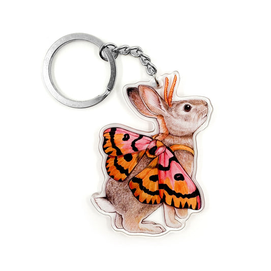 A keychain featuring an illustration of a desert cottontail dressed as a sheep moth