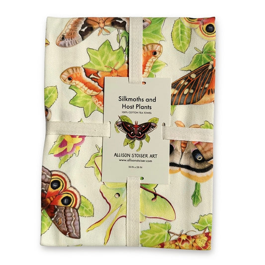 A ribbon-wrapped tea towel featuring moths on their host plants