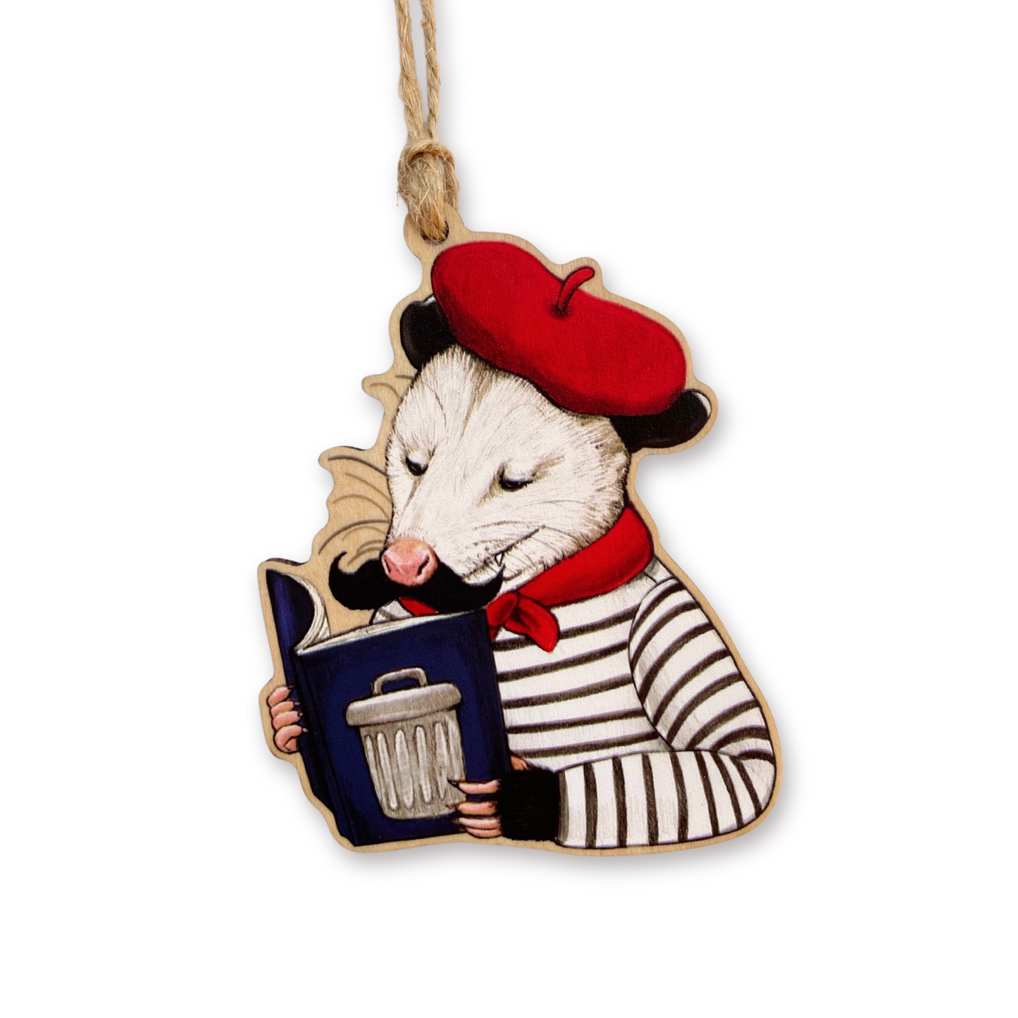 Decorative ornament of an opossum wearing a red beret and holding a book, hanging on a white background.