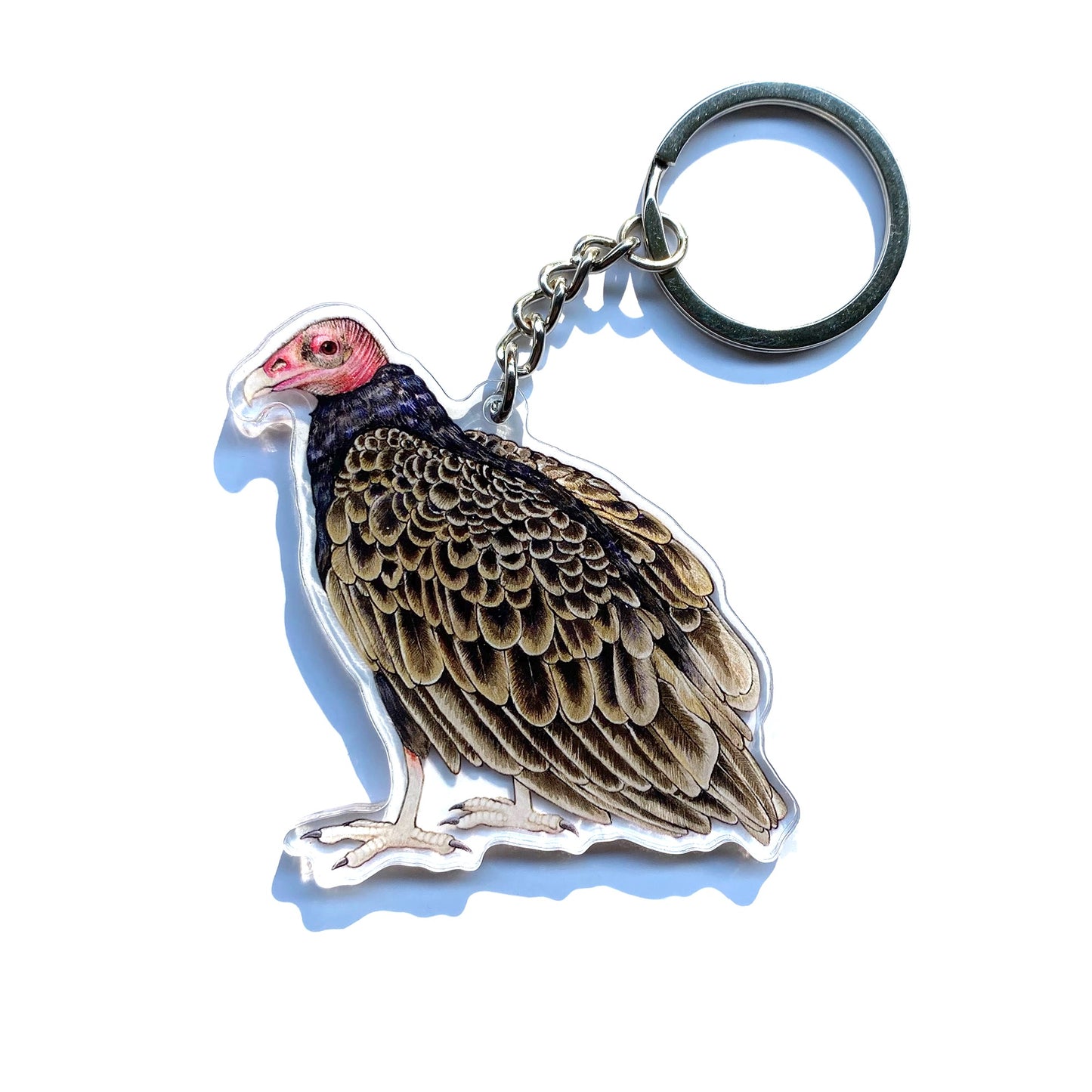 A turkey vulture keychain on a white background.